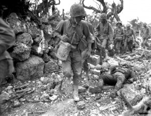 US Marines advance past the body of a Japanese KIA on Okinawa, 1945.