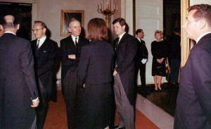 11/25/63 - Clint Hill (right) stands protectively near to Mrs. Kennedy ...