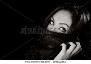 Sensual eyes of mysterious woman behind scarf - stock photo