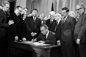 President Lyndon B. Johnson signs into law the Fair Housing Act during ...