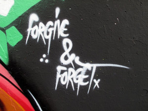 of the quote “forgive & forget” spray painted by a graffiti artist ...