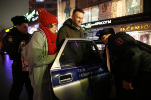 Opposition leader Alexei Navalny gets into a police car after he was ...