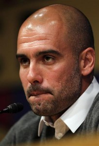 Barcelona's coach Pep Guardiola bites his lower lip during a news ...