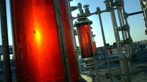 Oil is collected at a production facility at the Burgan oil field ...