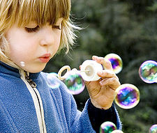 Child playing with bubbles