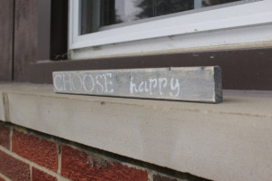 Small rustic wood sign with the quote “Choose happy”