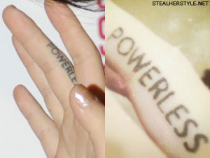 ... the word “POWERLESS” tattooed along the side of her middle finger