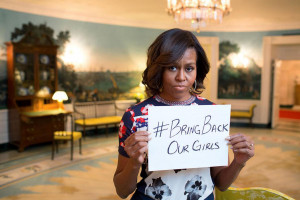 Image: First lady Michelle Obama holds a sign in support of the ...