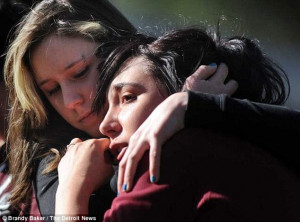 Disbelief: Calla Miller, 18, consoles Ashley Jendrusik, 17, outside ...