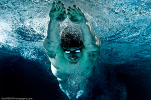 Breast Stroke swimmer in glide – underwater from front with dark ...