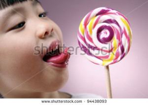 Attractive girl licking beautiful christmas lollipop - stock photo