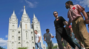 Gay rights activists hold hands in protest in front of the Mormon ...