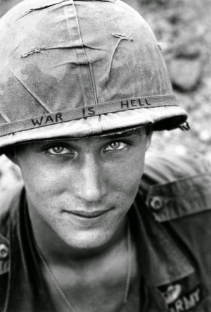 ... hand lettered “War Is Hell” slogan on his helmet, Vietnam, 1965