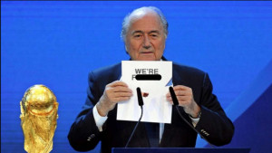 Sepp Blatter holding up a sign that says, 