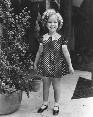 Shirley Temple wearing one of her classic outfits.