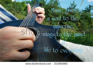 Inspirational quote on music by Plato, with a man's hand playing a ...