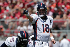 Denver Broncos quarterback Peyton Manning signals at the line of ...