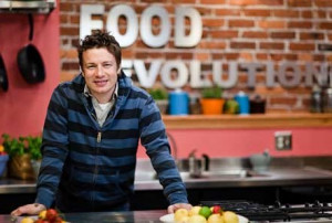 Jamie Oliver in a blue and black striped hoodie, smiling at his Food ...