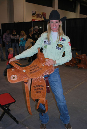 Sherry Cervi holding her 2013 world champion saddle, the fourth of her ...