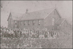 Pupils and teachers gather outside the Cheltenham State School, c1900.