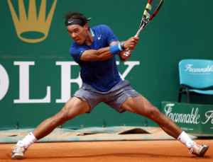 Rafael Nadal of Spain returns the ball to his compatriot David Ferrer ...