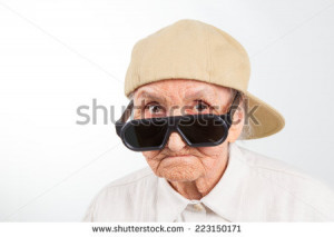 Funny grandma's studio portrait wearing eyeglasses and baseball cap ...