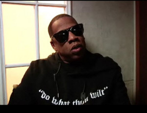 Rapper Jay-Z, wearing a line from Aleister Crowley's book on his shirt ...