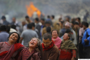 Family members break down during the cremation of earthquake victims ...
