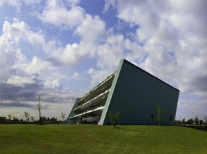 Trapezoid-Shaped Eye Bank Building Hugs a Slope of Stepped Green ...