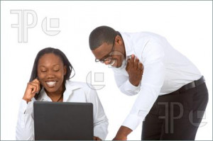 African-American young Couple by laptop laughing