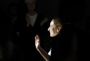 designer Miuccia Prada acknowledges the applause at the end of Prada ...