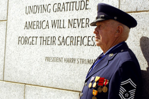 Master Sgt. Billy Neil poses near a quote by President Harry Truman ...