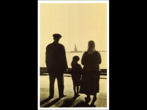Immigrant Family Looking At Statue Of Liberty From Ellis Island