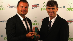 ... Tobin presents former Socceroo Mark Viduka with the Alex Tobin Medal