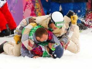 the U.S. (bottom) celebrates with team mates after the men's snowboard ...