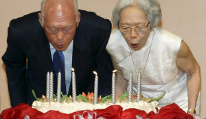 Singapore, and his wife Kwa Geok Choo (R) blow out candles on his ...