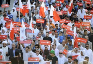Anti-government protesters with banners reading, ''I Love Bahrain ...