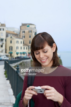 Young woman portrait with camera looking at display smiling old city ...