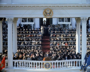 president john f kennedy sitting at his desk with flag in background ...