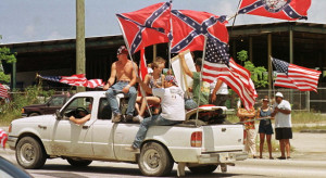 pickup truck decked out with Confederate and U.S. flags drives south ...