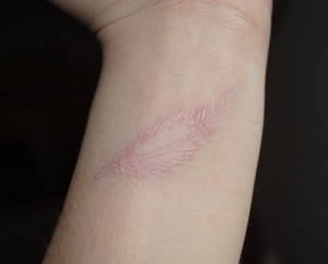 my white ink wrist tattoo #feather #whiteink