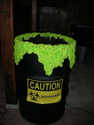 an old 55 gal barrel, black paint, a caution sticker and spray foam ...