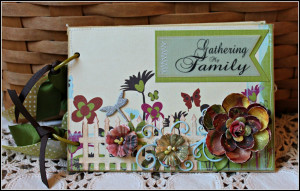 To the cover, I added some die cuts, chipboard and Prima flowers.