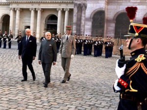 Modi is escorted by the French Foreign Minister Laurent Fabius ...