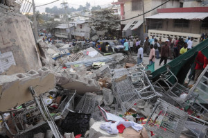 People gather in the street after an earthquake leveled many buildings ...