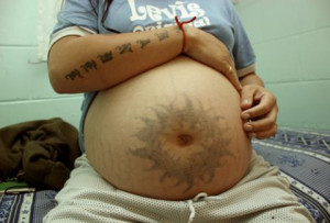 pregnant prisoner shows her tattoo while sitting in her cell at Prison ...
