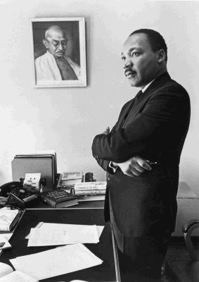 Martin Luther King, Jr. beside a picture of Gandhi. © Bob Fitch, all ...