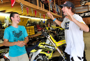 with travis travis showing a 1 bill autographed by travis pastrana