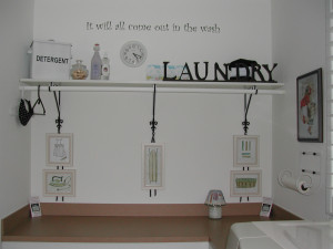 wall decal on the center of the laundry room with an accessory shelf ...