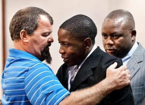 Tim See, left, hugs Takunda Mavima in the courtroom. See's son Timothy ...